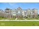 Beautiful townhomes featuring varied colors, brick accents, and professionally landscaped yards with sidewalks and green grass at 7344 W County Road 600, McCordsville, IN 46055