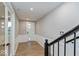 Inviting entryway hallway with wood floors, white trim, and a modern front door at 7344 W County Road 600, McCordsville, IN 46055