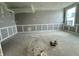 Unfinished living space ready for personalization with wainscoting along the walls and a window at 7344 W County Road 600, McCordsville, IN 46055