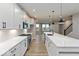 Modern kitchen features white cabinets, stainless steel appliances, an island with a sink, and hardwood floors at 7344 W County Road 600, McCordsville, IN 46055
