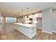 Bright kitchen with modern stainless steel appliances, recessed lighting, a large island and wood flooring at 7344 W County Road 600, McCordsville, IN 46055
