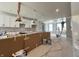 A work-in-progress kitchen featuring white cabinets, paint supplies, and a worker on a ladder at 7344 W County Road 600, McCordsville, IN 46055
