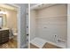 A laundry and half bathroom with vinyl flooring and gray walls at 7344 W County Road 600, McCordsville, IN 46055