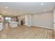 Spacious living room with light wood floors seamlessly connects to the modern kitchen and staircase at 7344 W County Road 600, McCordsville, IN 46055