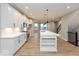 Open concept living space with wood flooring, recessed lighting and great views of the kitchen and staircase at 7344 W County Road 600, McCordsville, IN 46055