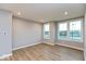 Bright, open living space with wood flooring, natural light, and neutral wall paint at 7344 W County Road 600, McCordsville, IN 46055