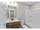 Modern bathroom with tub, toilet, and wooden vanity at 7348 W County Road 600 Rd # 12-604, McCordsville, IN 46055