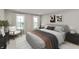 Comfortable bedroom featuring a neutral color scheme, plush bedding, modern artwork, and ample natural light at 7348 W County Road 600 Rd # 12-604, McCordsville, IN 46055