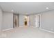 Carpeted bedroom featuring multiple access doors and neutral paint at 7348 W County Road 600 Rd # 12-604, McCordsville, IN 46055