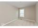 A cozy carpeted bedroom with a window at 7348 W County Road 600 Rd # 12-604, McCordsville, IN 46055