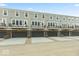 Row of townhomes with garages and balconies at 7348 W County Road 600 Rd # 12-604, McCordsville, IN 46055