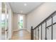 Beautiful staircase with hardwood floors leading to the home's front door at 7348 W County Road 600 Rd # 12-604, McCordsville, IN 46055