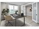 A well-lit home office with a modern desk, chair, large windows, and french doors leading to another room at 7348 W County Road 600 Rd # 12-604, McCordsville, IN 46055