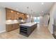 Bright kitchen with a central island, modern pendant lights, and stainless steel appliances at 7348 W County Road 600 Rd # 12-604, McCordsville, IN 46055