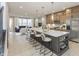 A spacious kitchen with a large island, modern appliances, and sleek countertops, open to a living area at 7348 W County Road 600 Rd # 12-604, McCordsville, IN 46055