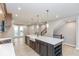 Spacious kitchen with a large island and a farmhouse sink at 7348 W County Road 600 Rd # 12-604, McCordsville, IN 46055
