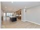 Open kitchen concept with island, stainless appliances, and views into dining area at 7348 W County Road 600 Rd # 12-604, McCordsville, IN 46055