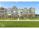 Charming townhomes featuring diverse facades and lush landscaping enhancing curb appeal at 7348 W County Road 600 Rd # 12-604, McCordsville, IN 46055