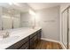 Bathroom featuring double sinks, modern lighting, shower with glass doors, and wood-look floors at 7352 W County Road 600, McCordsville, IN 46055