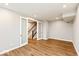 Open room with hardwood floors, recessed lighting and entrance to the staircase at 7352 W County Road 600, McCordsville, IN 46055