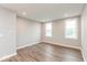 Bedroom with wood-look flooring, neutral walls, and bright natural light at 7352 W County Road 600, McCordsville, IN 46055