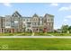 New townhomes feature brick accents, colorful front doors, and manicured landscaping at 7352 W County Road 600, McCordsville, IN 46055