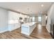 Modern kitchen features an island with quartz countertop and stainless steel appliances at 7352 W County Road 600, McCordsville, IN 46055