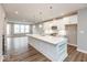Modern kitchen features an island with quartz countertop and stainless steel appliances at 7352 W County Road 600, McCordsville, IN 46055