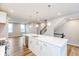 Modern kitchen features an island with quartz countertop and stainless steel appliances at 7352 W County Road 600, McCordsville, IN 46055