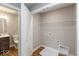 Convenient first-floor laundry room adjacent to bathroom with built in shelving at 7352 W County Road 600, McCordsville, IN 46055