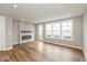 Bright living room with fireplace, wood-look flooring, and plenty of natural light at 7352 W County Road 600, McCordsville, IN 46055