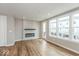 Bright living room with fireplace, wood-look flooring, and plenty of natural light at 7352 W County Road 600, McCordsville, IN 46055