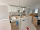 New kitchen with white cabinets and a modern island being installed at 7352 W County Road 600 Rd, McCordsville, IN 46055