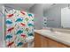 bathroom features a shower/tub combo with a cheerful dinosaur-themed curtain at 800 Gondola Run, Greenfield, IN 46140