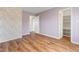 Bedroom with hardwood floors, floral wallpaper, and a walk-in closet at 800 Gondola Run, Greenfield, IN 46140