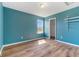Bright bedroom with hardwood floors, a window and a walk-in closet, freshly painted in blue at 800 Gondola Run, Greenfield, IN 46140