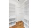 Walk-in closet with wood floor, shelving and hanging rods for maximum storage at 800 Gondola Run, Greenfield, IN 46140