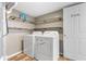 Convenient laundry room featuring modern washer and dryer units, accompanied by rustic shelving at 800 Gondola Run, Greenfield, IN 46140