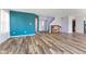 Bright living room featuring wood flooring, a piano, and an entryway with stairs to the upper level at 800 Gondola Run, Greenfield, IN 46140