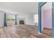 Inviting living room with a cozy fireplace, wood floors, and natural light from large windows at 800 Gondola Run, Greenfield, IN 46140