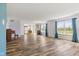 Open living area with wood floors, large windows, and views into the modern kitchen at 800 Gondola Run, Greenfield, IN 46140