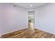 Spacious room featuring wood flooring, neutral walls, and open doorway to the living area at 800 Gondola Run, Greenfield, IN 46140