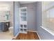 Walk-in closet features vinyl floors, a storage system, and a vanity with a window for natural light at 800 Gondola Run, Greenfield, IN 46140
