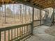 Covered patio with stairs leading to backyard featuring mature trees at 1242 Bitterwood Ct, Columbus, IN 47201