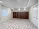 Finished basement rec room featuring large built-in shelving and neutral carpet at 1242 Bitterwood Ct, Columbus, IN 47201