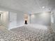 Spacious finished basement with carpeted flooring and a wet bar visible in the background at 1242 Bitterwood Ct, Columbus, IN 47201