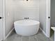 Bright bathroom showcasing a freestanding tub with a horizontal wood accent wall at 1242 Bitterwood Ct, Columbus, IN 47201
