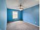 Bedroom featuring blue walls, carpeted floor, natural light from the window, and ceiling fan at 1242 Bitterwood Ct, Columbus, IN 47201