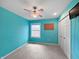 Bedroom with a blue accent wall, carpeted floor, ceiling fan and closet for ample storage at 1242 Bitterwood Ct, Columbus, IN 47201