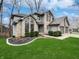 Charming two-story home with well-manicured lawn and a three-car garage at 1242 Bitterwood Ct, Columbus, IN 47201